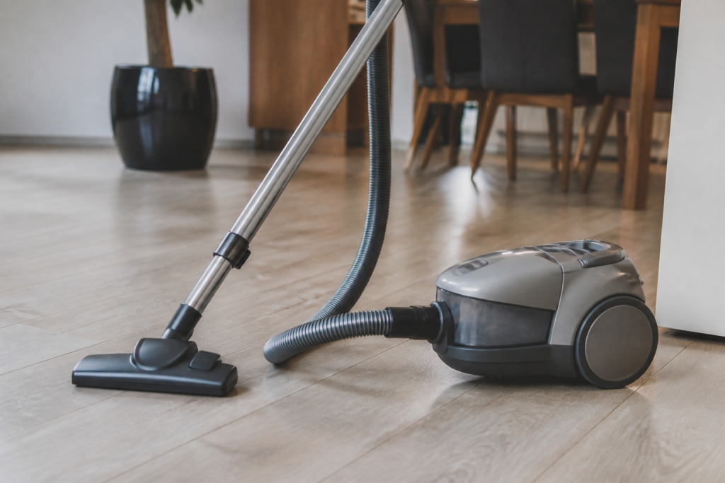 Aspirateur gris sur sol stratifie lumineux